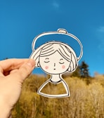 person holding white and black cartoon character