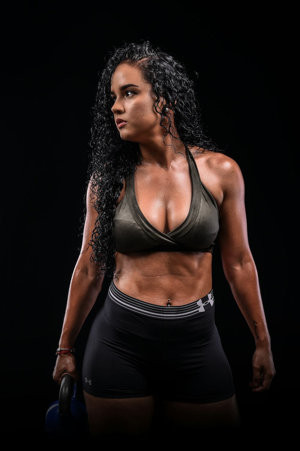 A woman in a sports bra top is using a stationary exercise machine photo –  Working out Image on Unsplash