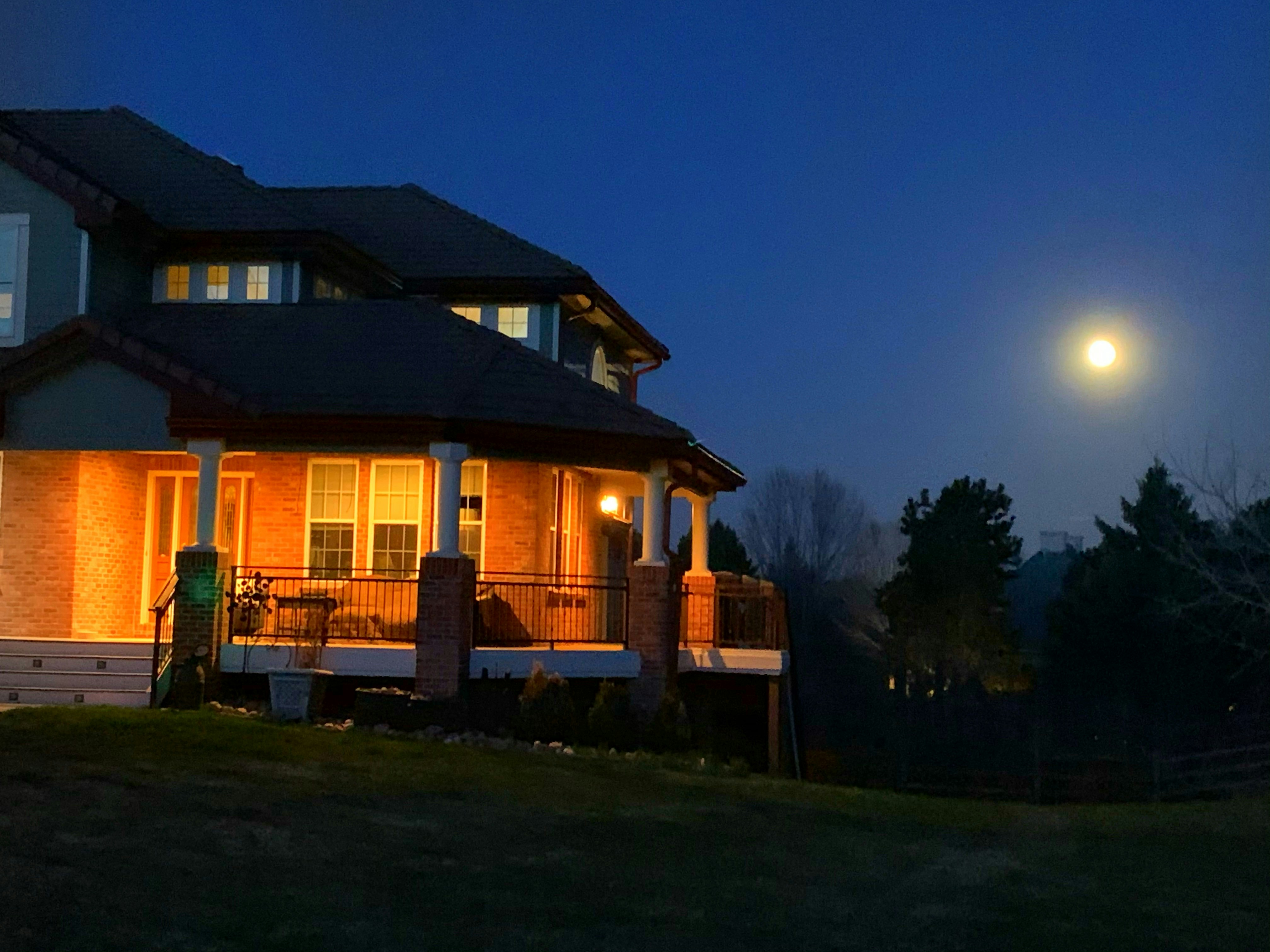 a completed, beautifully lit new home at dusk - new construction electrician richardson