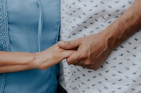 person in blue shirt and white and black pants