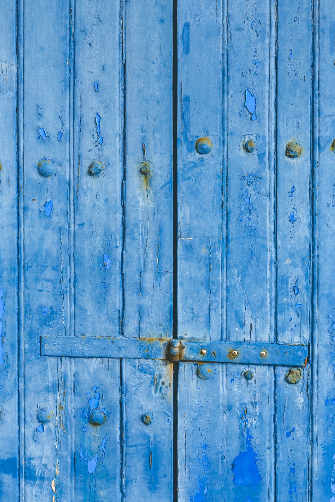 blue wooden door with padlock