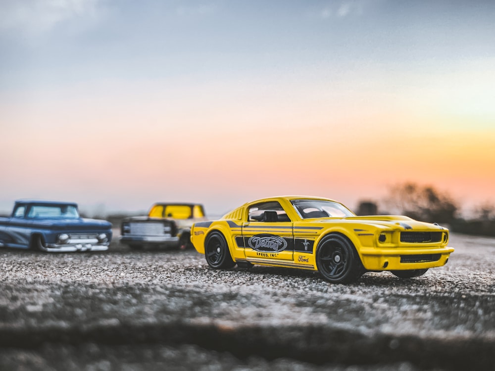 yellow and black chevrolet camaro on gray sand during daytime