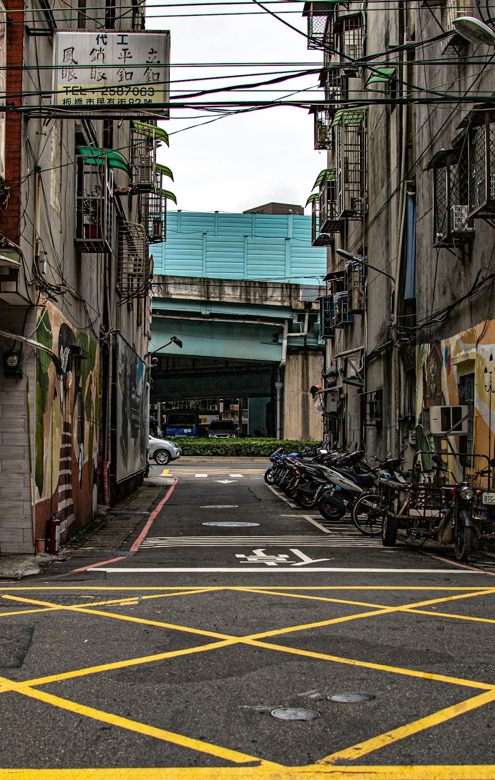 cars parked on sidewalk beside buildings during daytime