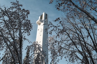 white concrete tower under blue sky during daytime