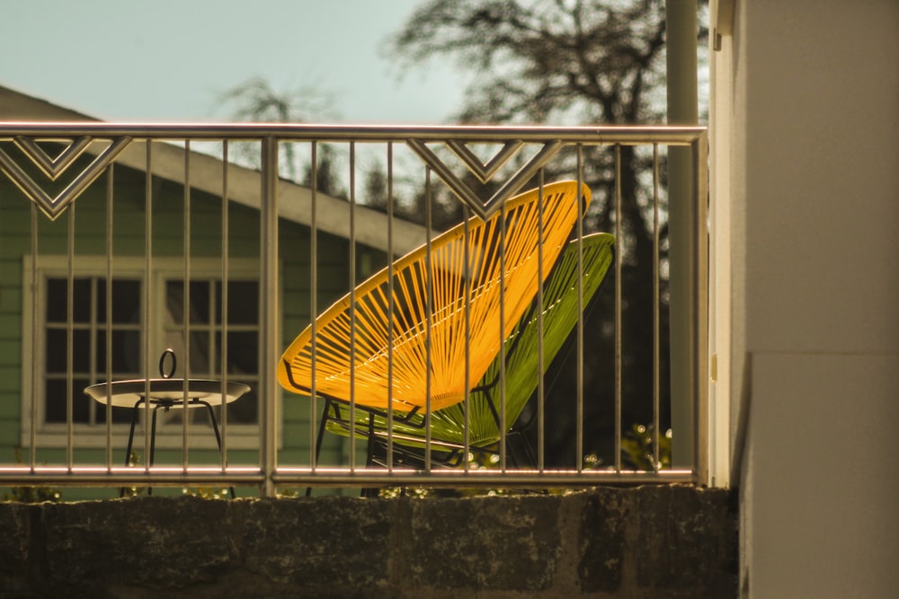 yellow and green umbrella on brown wooden table