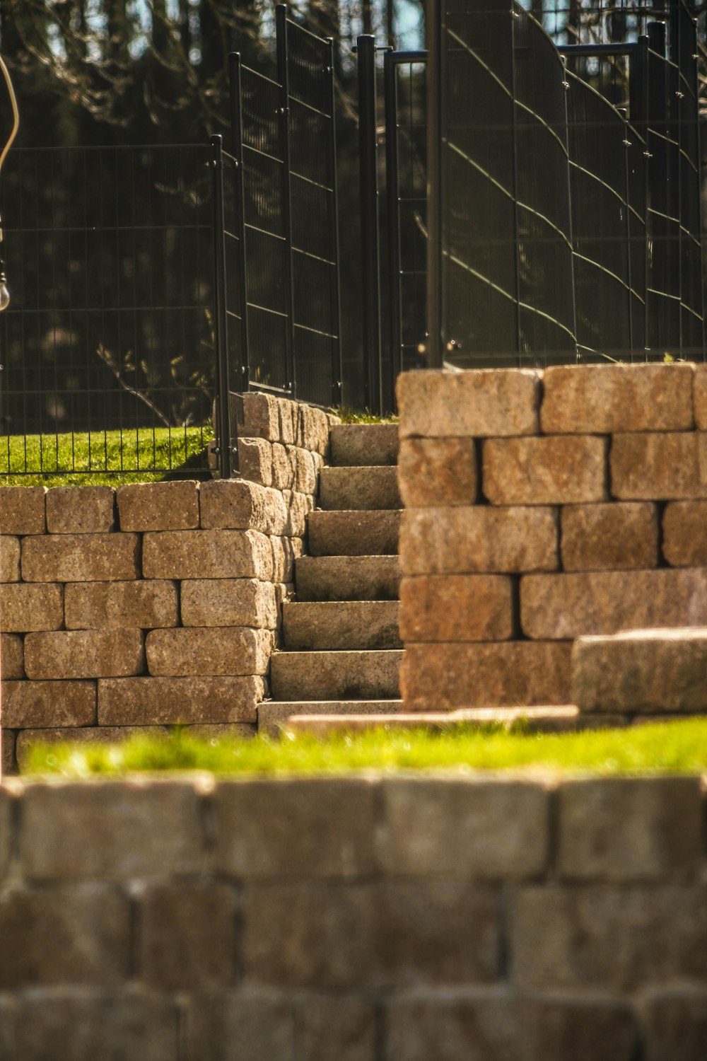 brown brick wall near green grass during daytime