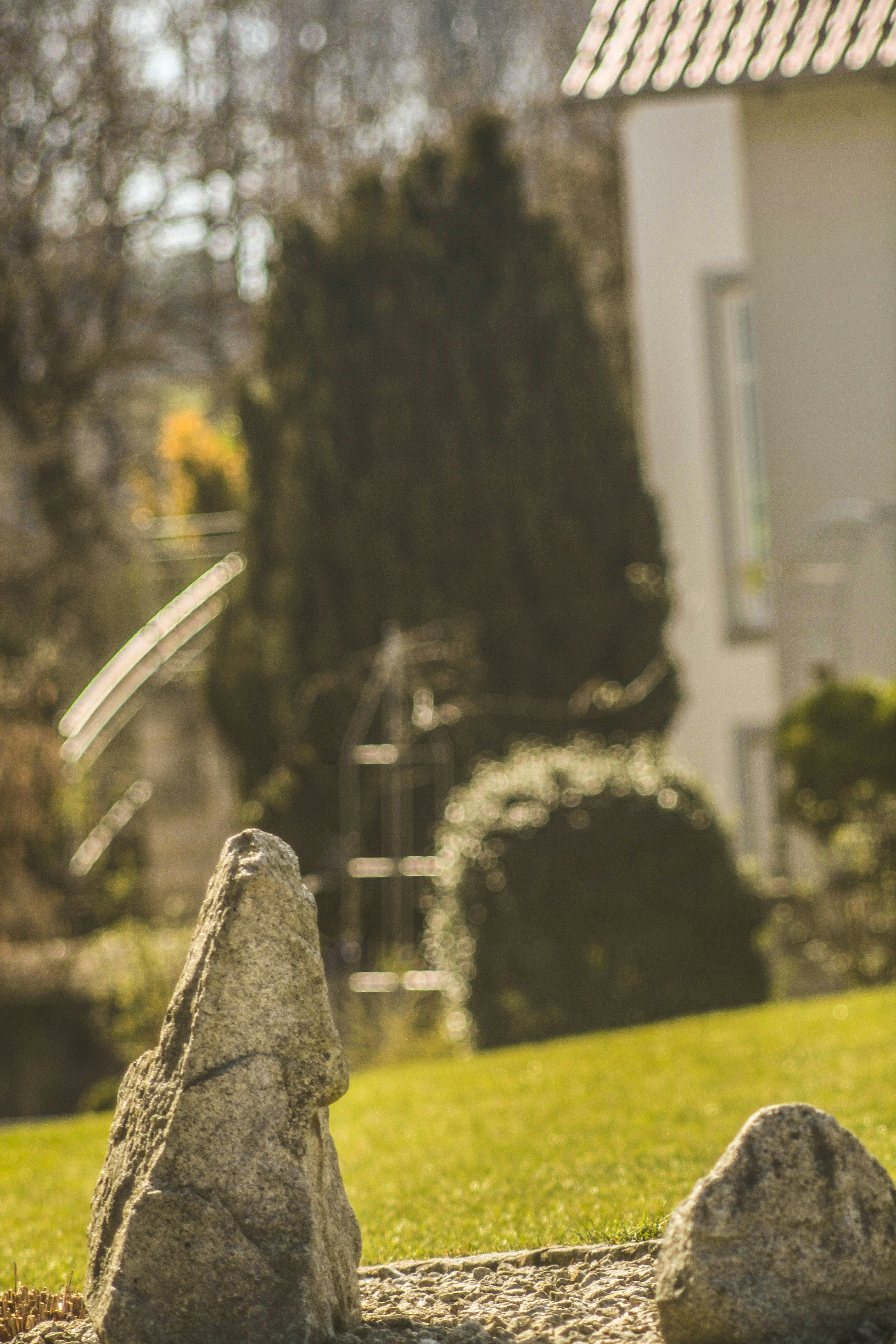 gray concrete cross on green grass field during daytime
