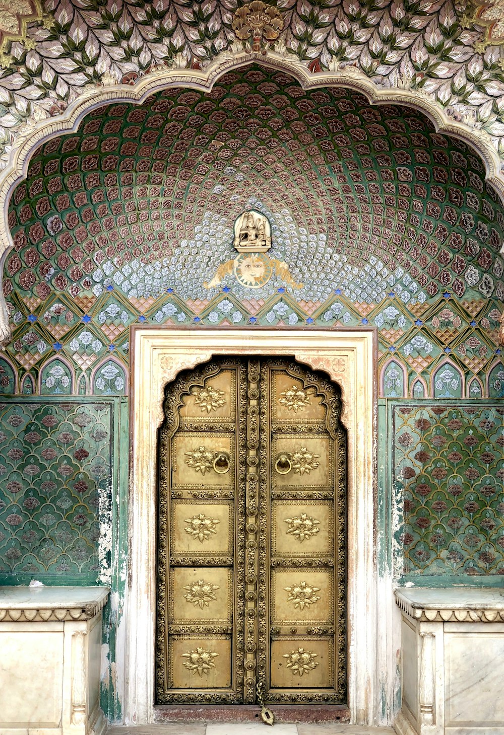 brown wooden door on green and brown concrete building