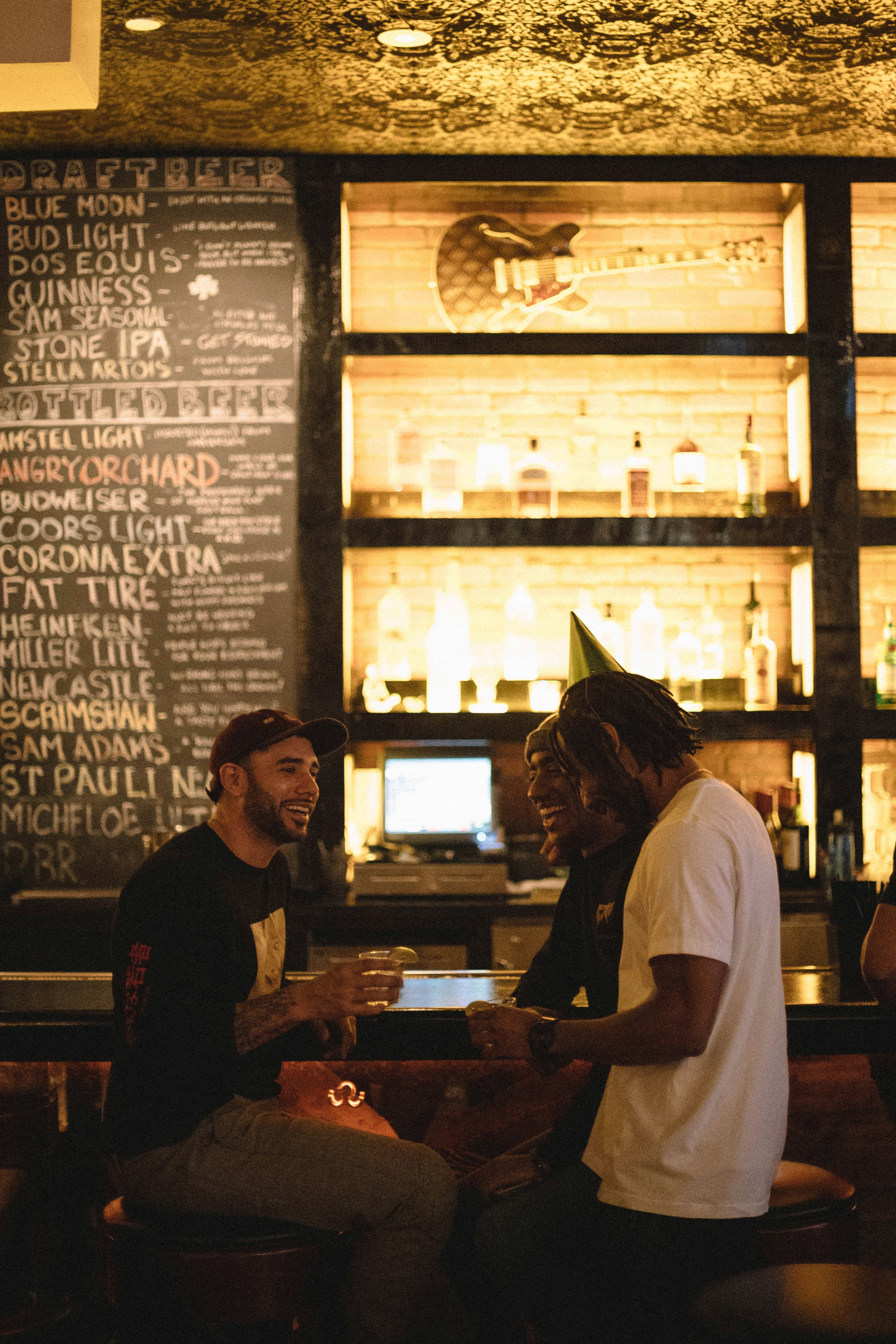Man in black crew neck tshirt standing beside woman in white tshirt