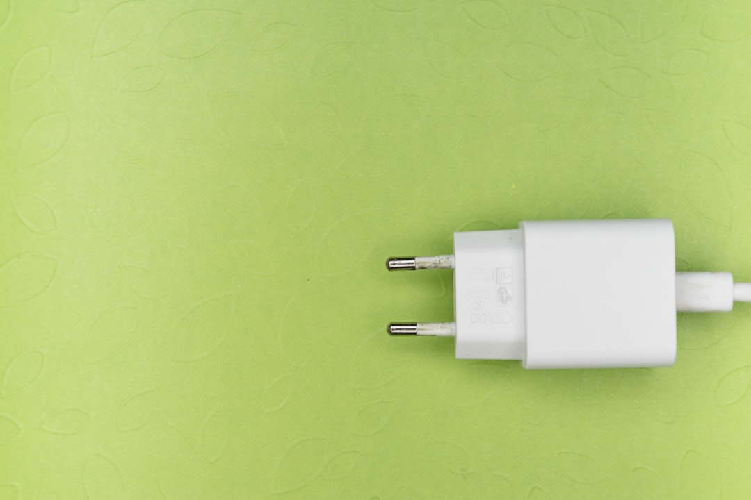 white adapter on green surface