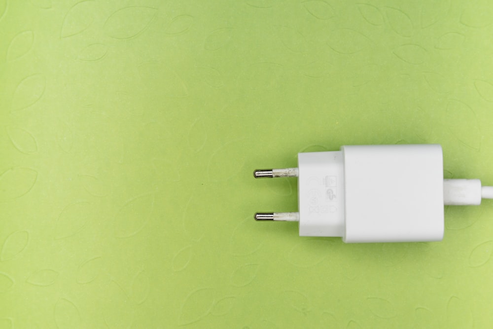 white adapter on green surface