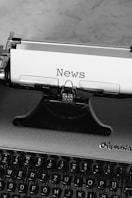 black and white typewriter on black table