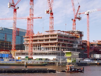 red and gray crane near building during daytime