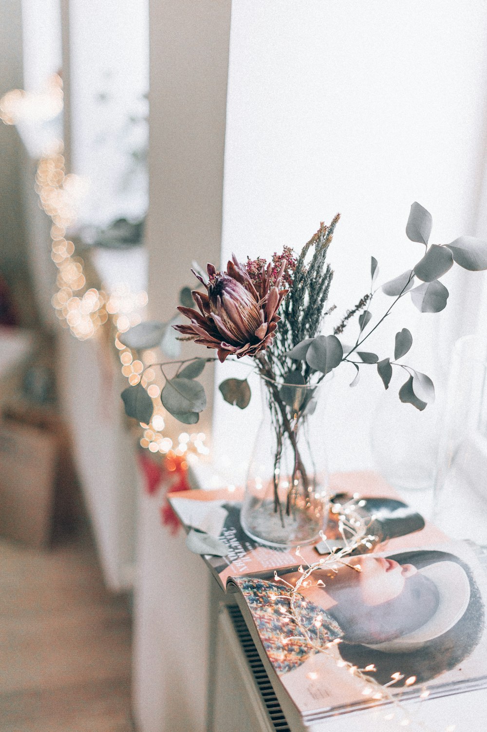 red roses in clear glass vase on table