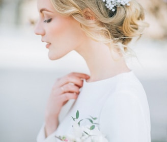 woman in white long sleeve shirt with white flower headband
