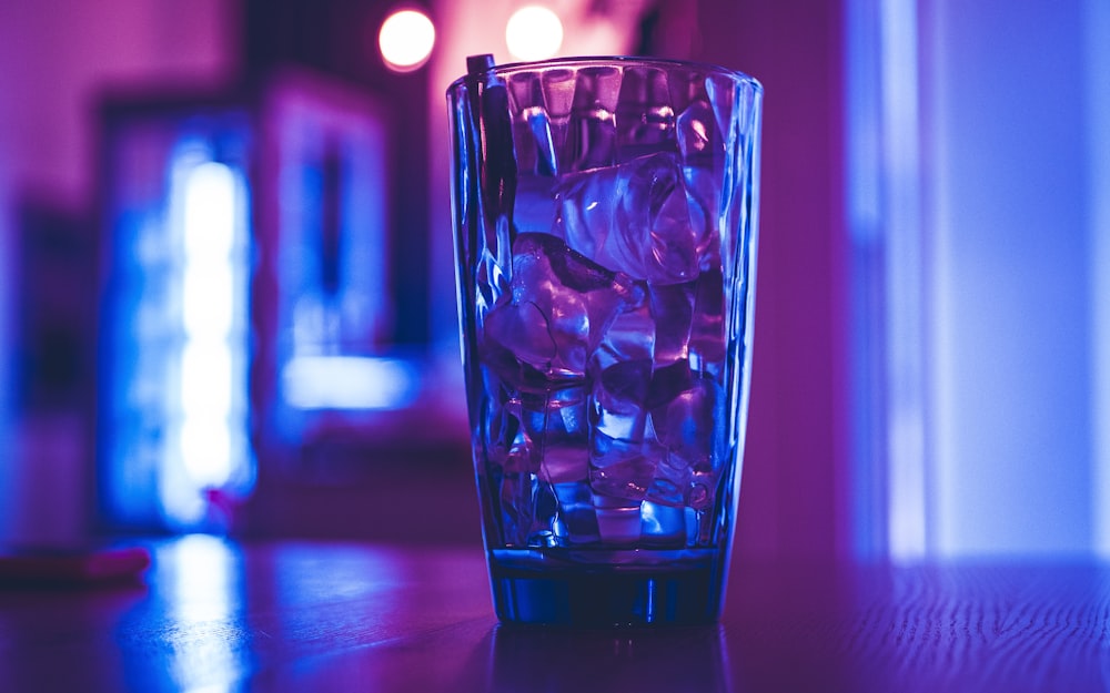 clear drinking glass on brown wooden table