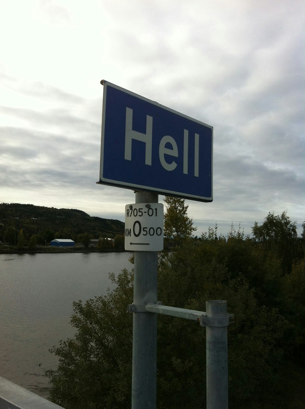 a blue street sign sitting on the side of a road