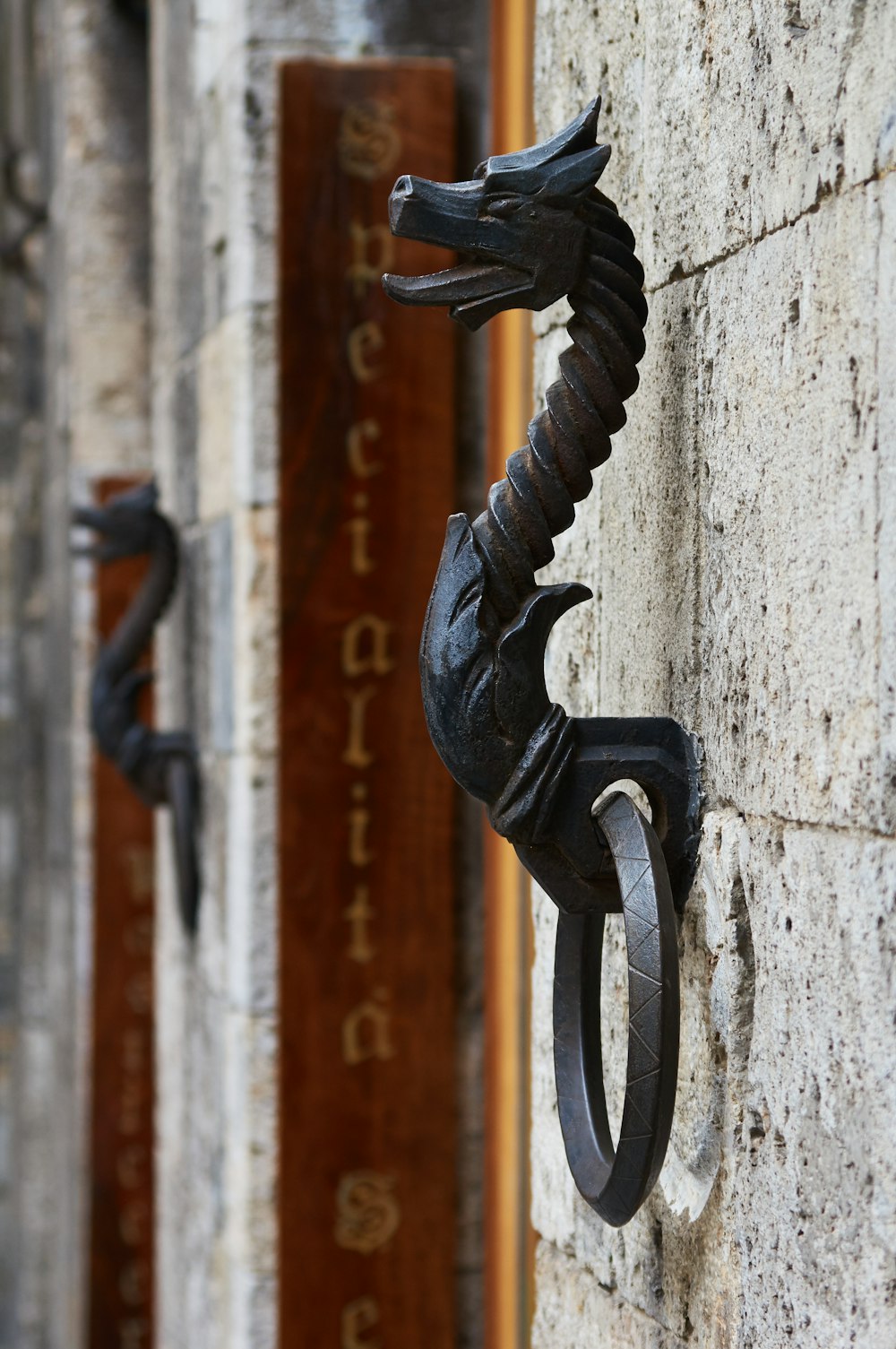 black metal door handle on white concrete wall