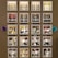 A wall display features various bottles of wine organized into individual illuminated cubbyholes. Each section has a handwritten label indicating categories such as Chardonnay, Bubbles, and Napa. Decorative elements include small paper ornaments.