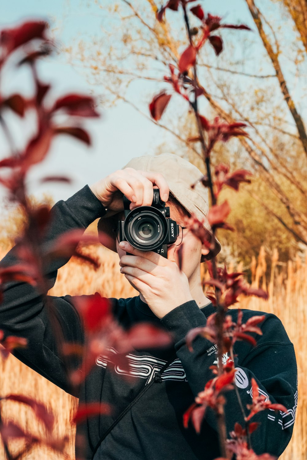 person holding black dslr camera