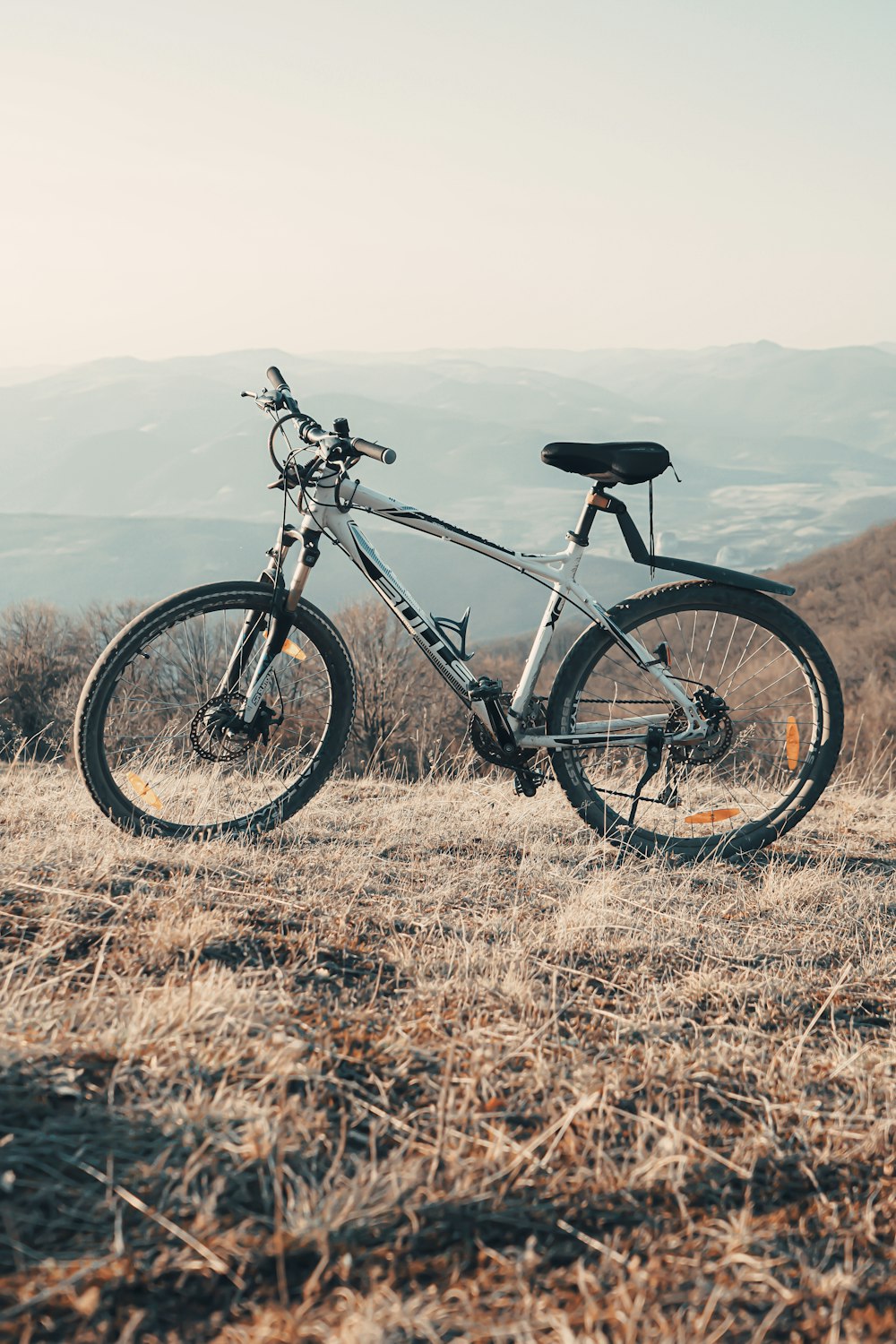 black and white hardtail mountain bike on brown grass field during daytime
