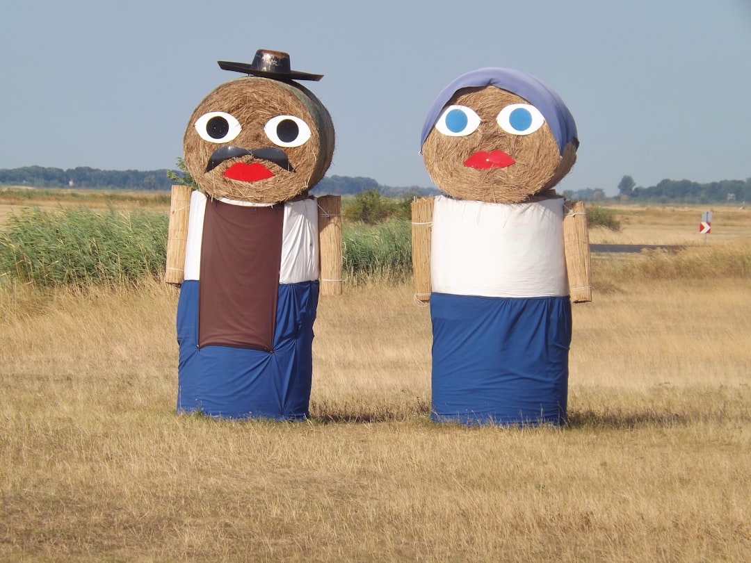 A couple, woman and man, created out of hay balls in Hungary, in the Puszta near the town Hortobagy. Europe.