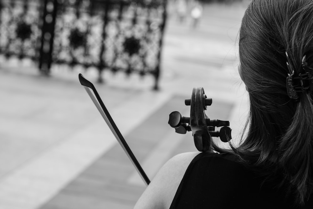 woman in black tank top playing violin