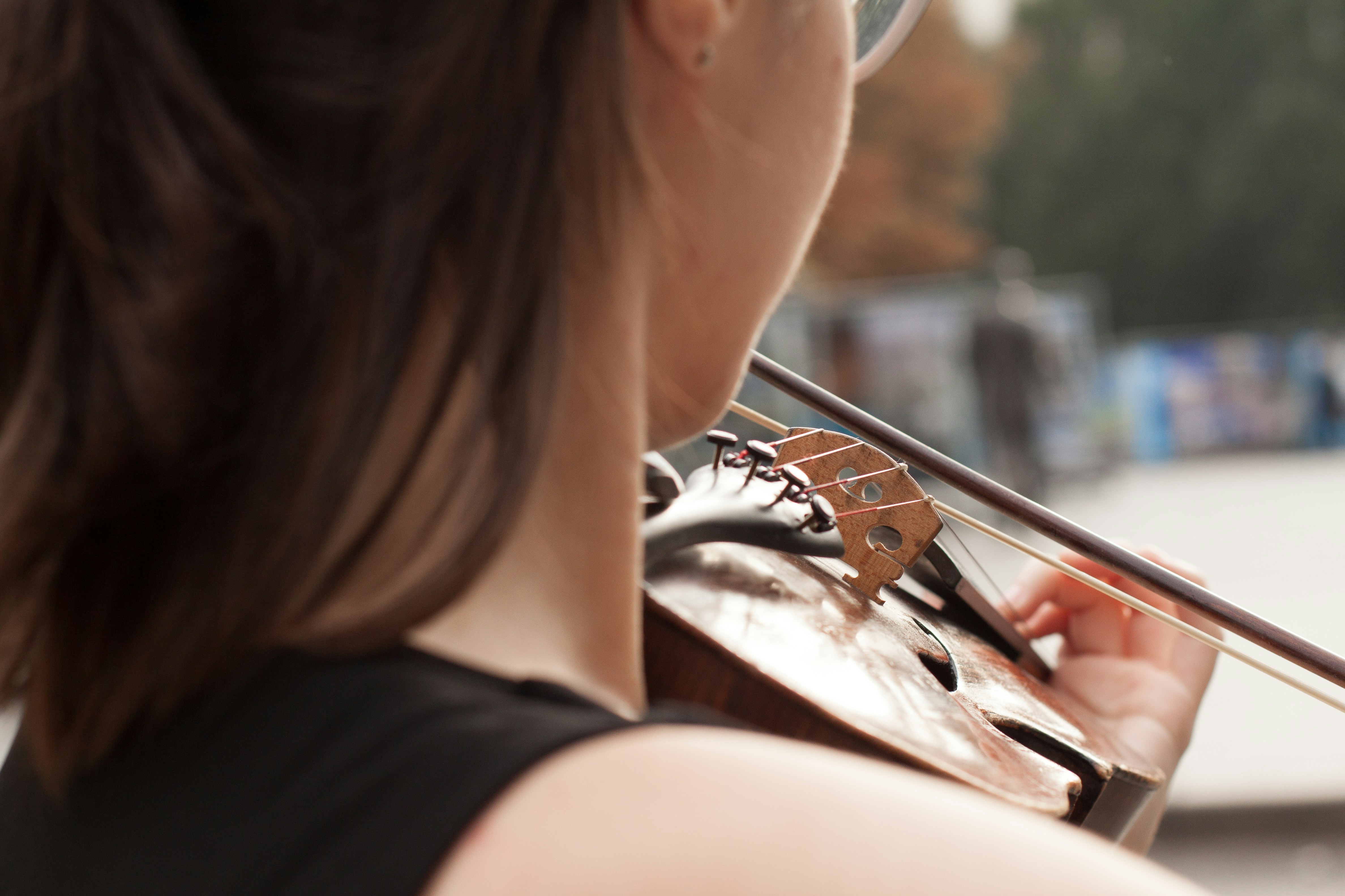 woman in black tank top playing violin