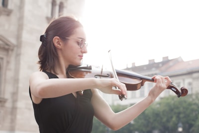 A boy playing the violin during a community talent showcase event.