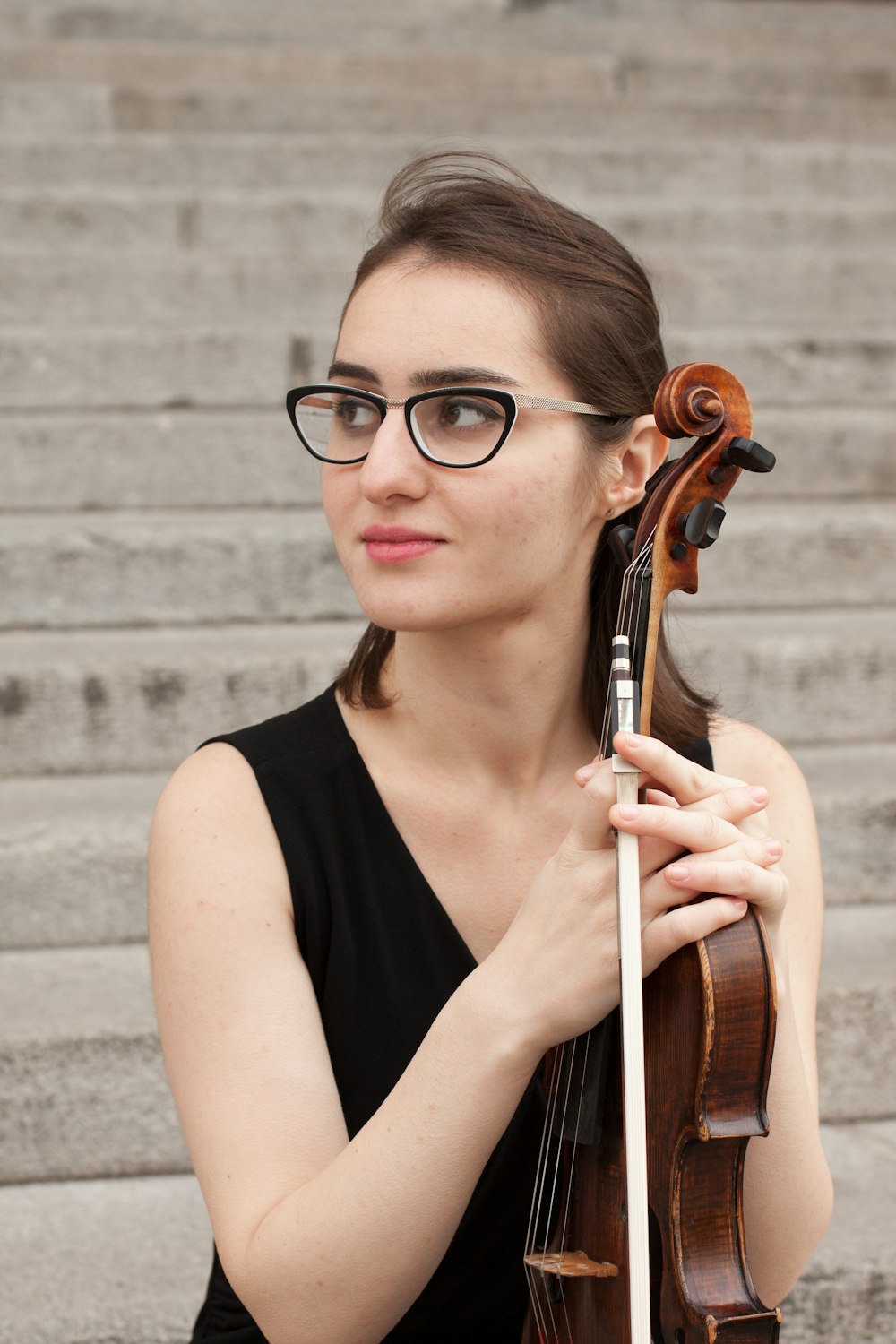 woman in black tank top playing brown violin