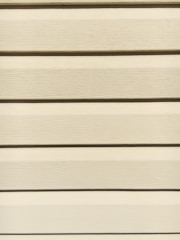 Horizontal beige siding panels with a textured surface. The panels are evenly spaced and aligned, providing a uniform appearance.