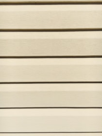 Horizontal beige siding panels with a textured surface. The panels are evenly spaced and aligned, providing a uniform appearance.