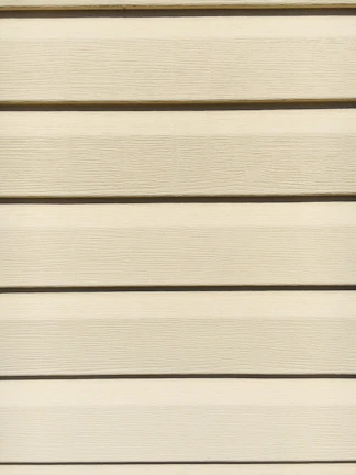Workers carefully fitting fiber cement siding panels on a two-story residence.