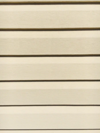 Close-up of a freshly installed siding panel showcasing the texture and quality of Ruffo siding.