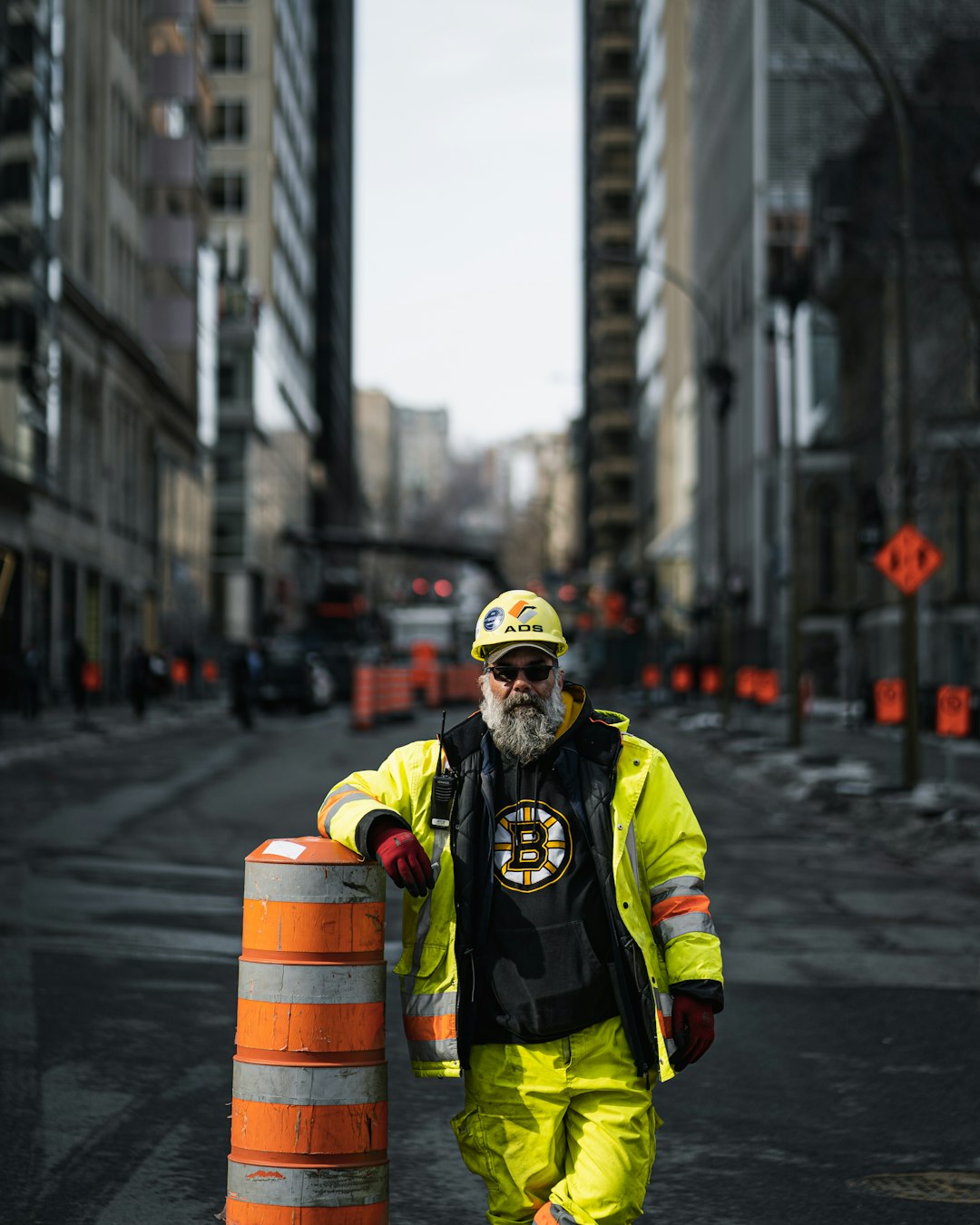 man in green and black jacket wearing yellow helmet and yellow helmet