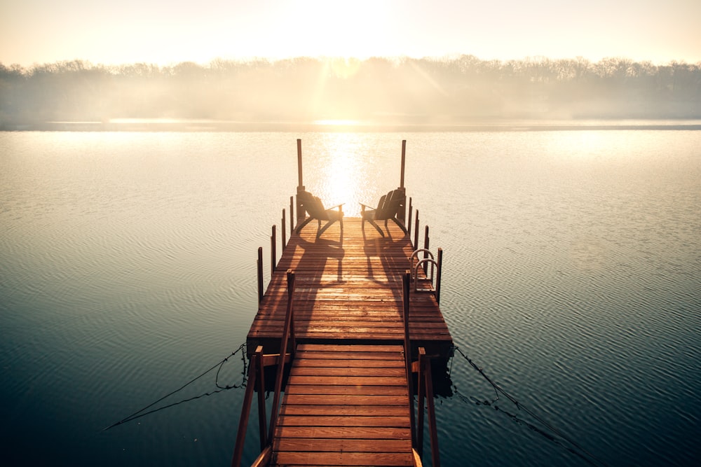 brown wooden dock on body of water during daytime