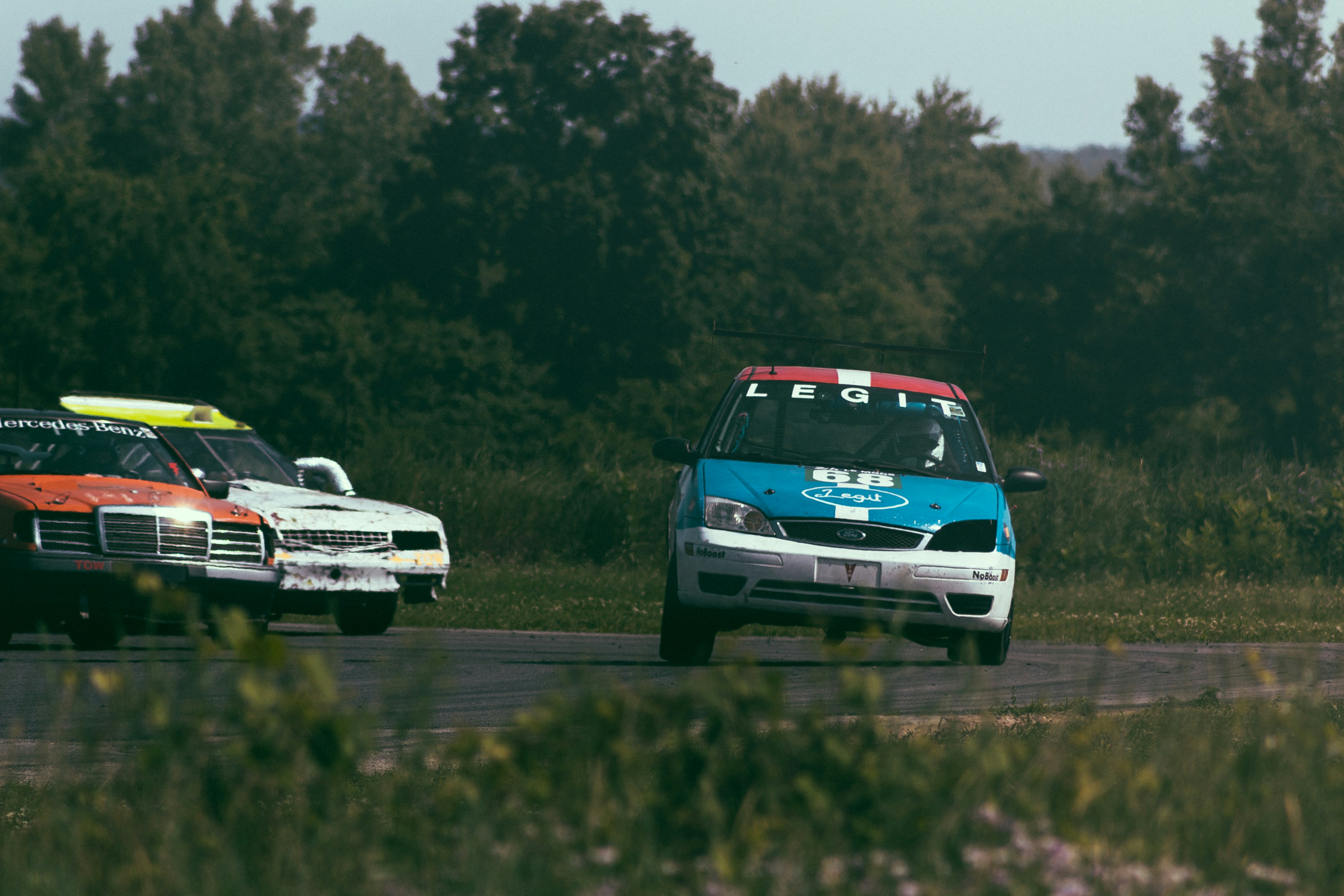 white and blue chevrolet camaro on road during daytime