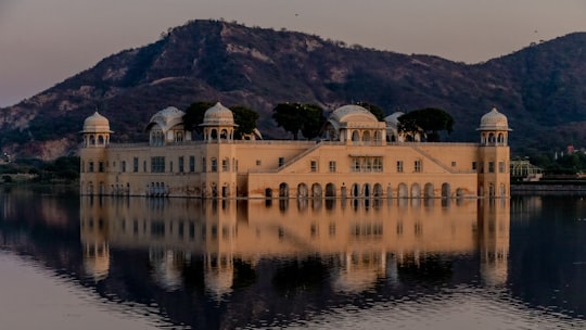 white concrete building near lake in Jal Mahal India