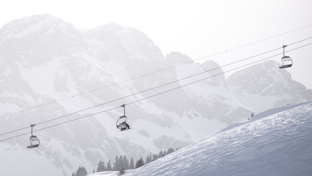 black cable car over snow covered mountain