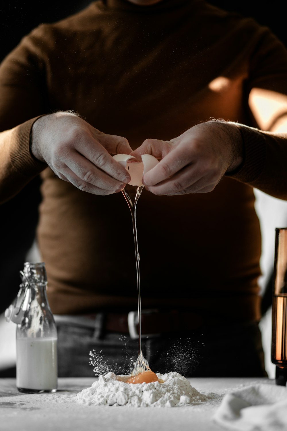 person in brown long sleeve shirt holding silver fork