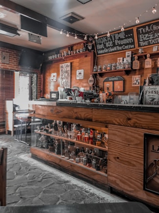 Cozy interior of a coffee shop with wooden furniture and soft lighting.