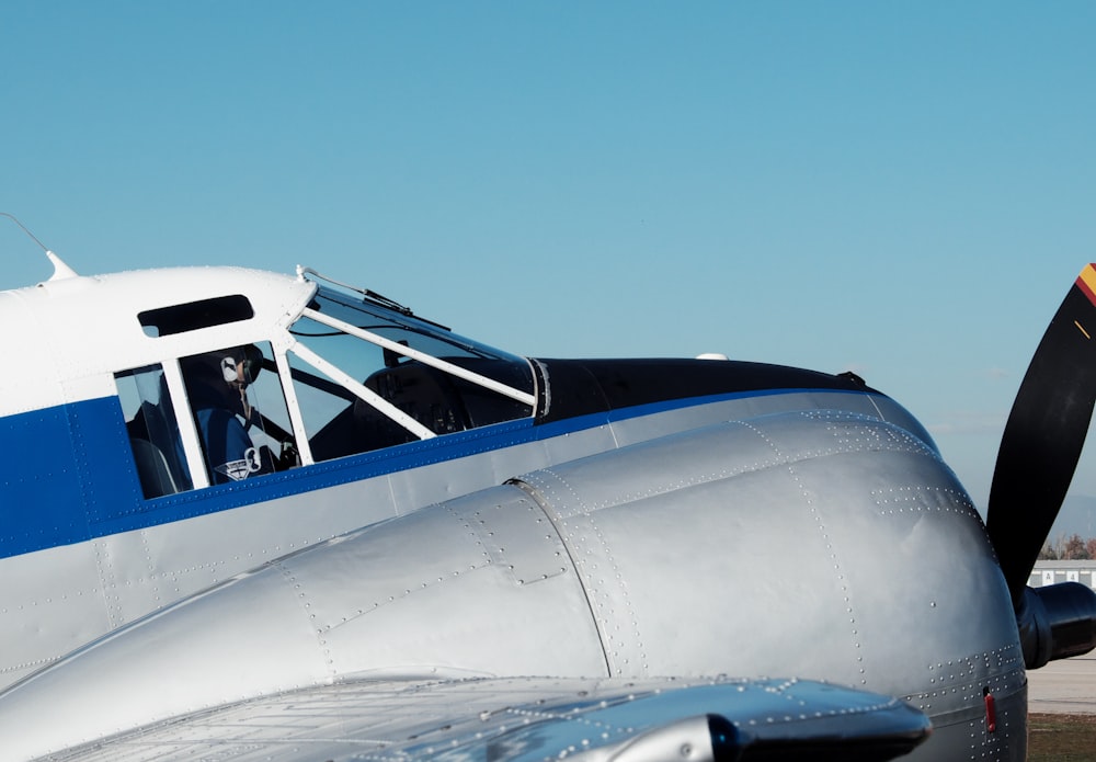 white and blue passenger plane under blue sky during daytime