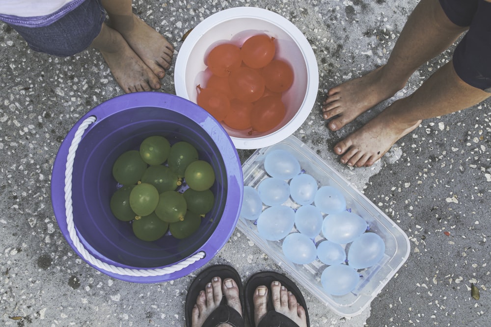 green round fruits in green plastic container