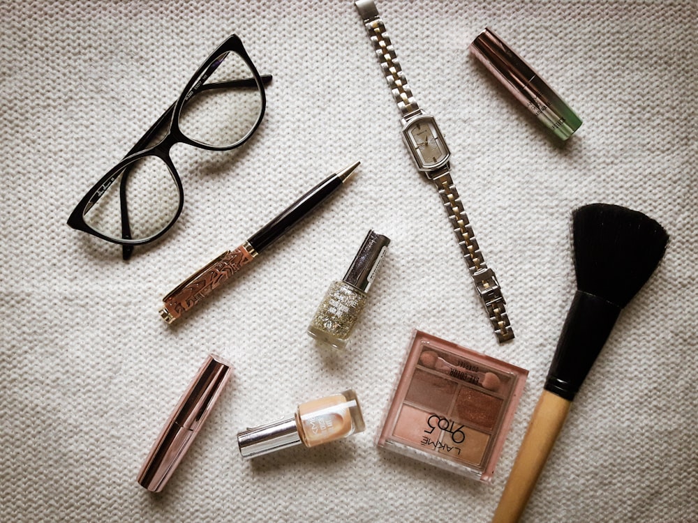 black framed eyeglasses black and pink lipstick and pink nail polish