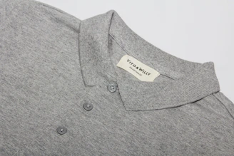 A polo shirt laid out flat, showcasing its breathable fabric and soft texture.