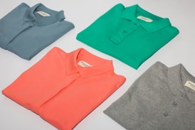 green crew neck shirt and gray crew neck shirt