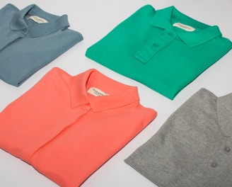 green crew neck shirt and gray crew neck shirt