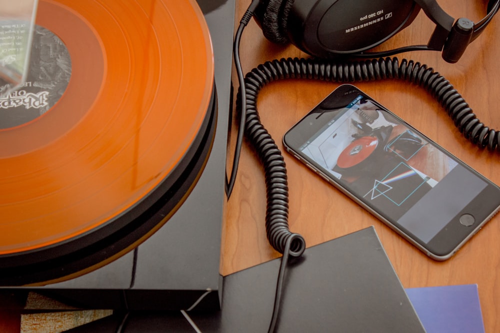 black sony headphones on brown wooden table