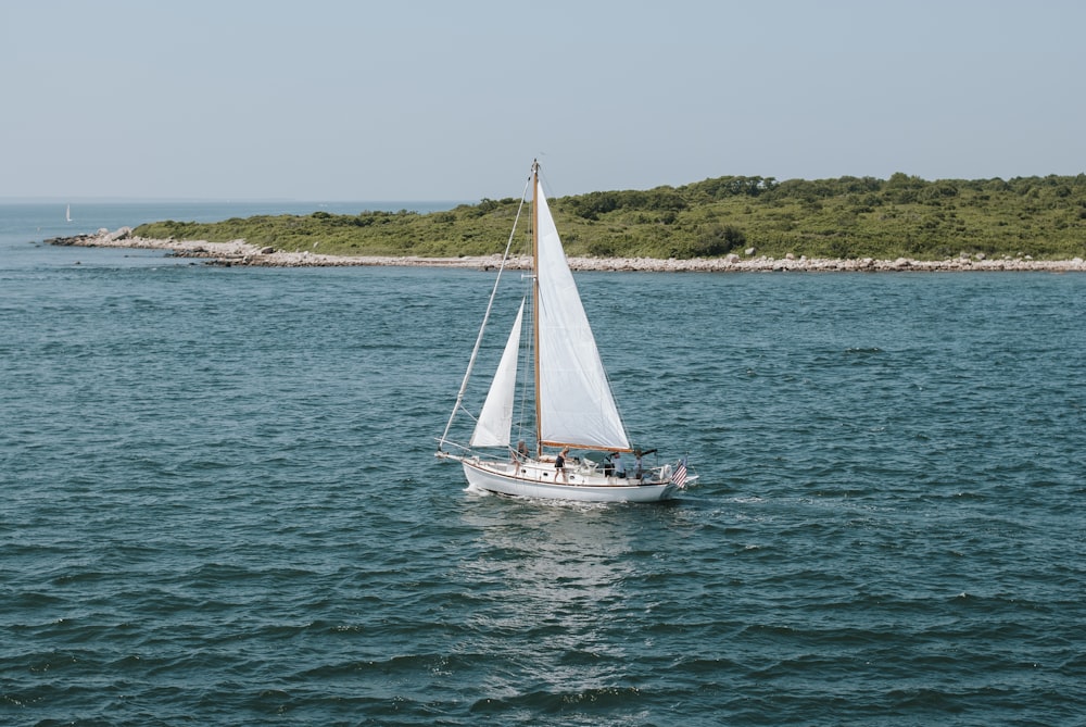 a sailboat in the middle of a body of water