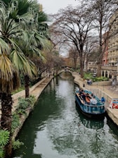 boat on river between trees during daytime